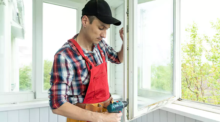 Skilled worker installing window frame with precision