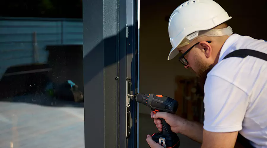 Worker securing window frame during construction project